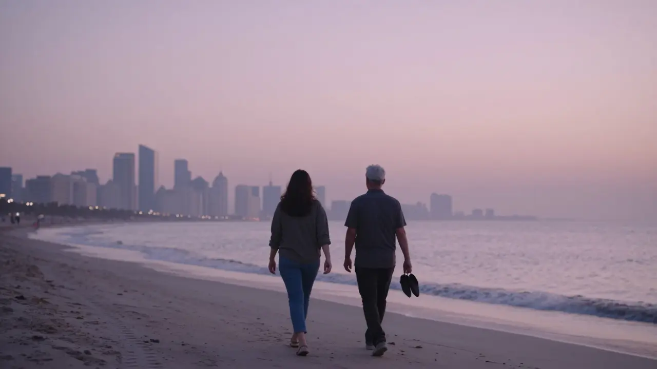 Two people walking barefoot along a quiet Dubai beach at dawn, the skyline softly visible in the distance.